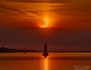 Annular eclipse over lighthouse